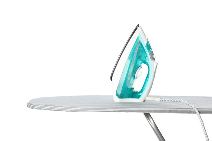 Iron on ironing board isolated on blank background
