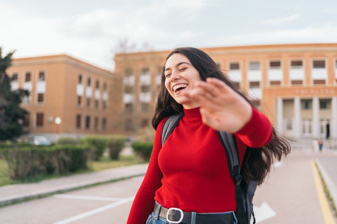 Female students portrait laughing and covering her face with her hand