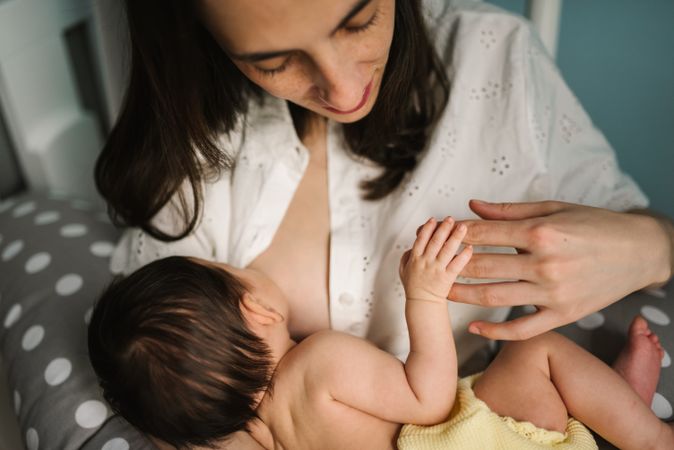 Mother feeding baby at home