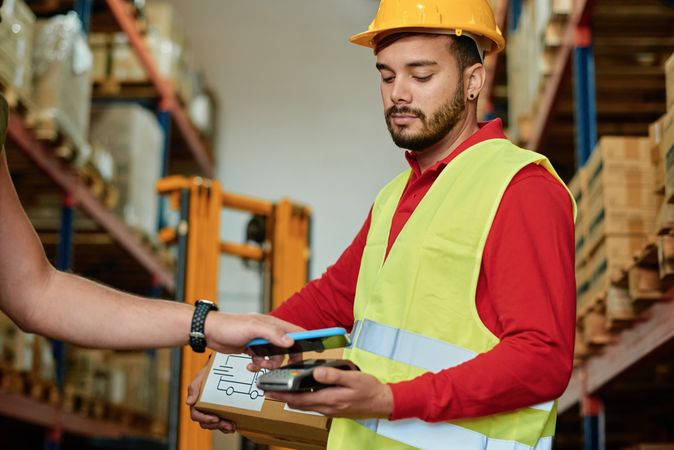 Warehouse worker scanning barcode on smartphone