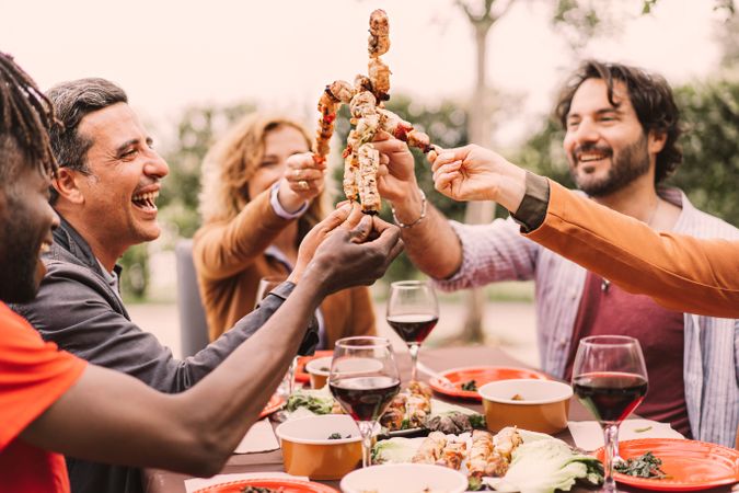 Outdoor shot of multi-ethnic friends enjoying barbecue party in garden