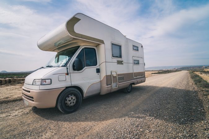 White trailer on empty road along desert