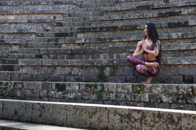 Woman practicing yoga in Toe Stand pose