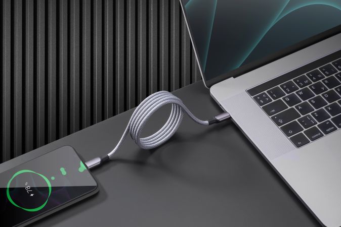 Smartphone connected to laptop for charging