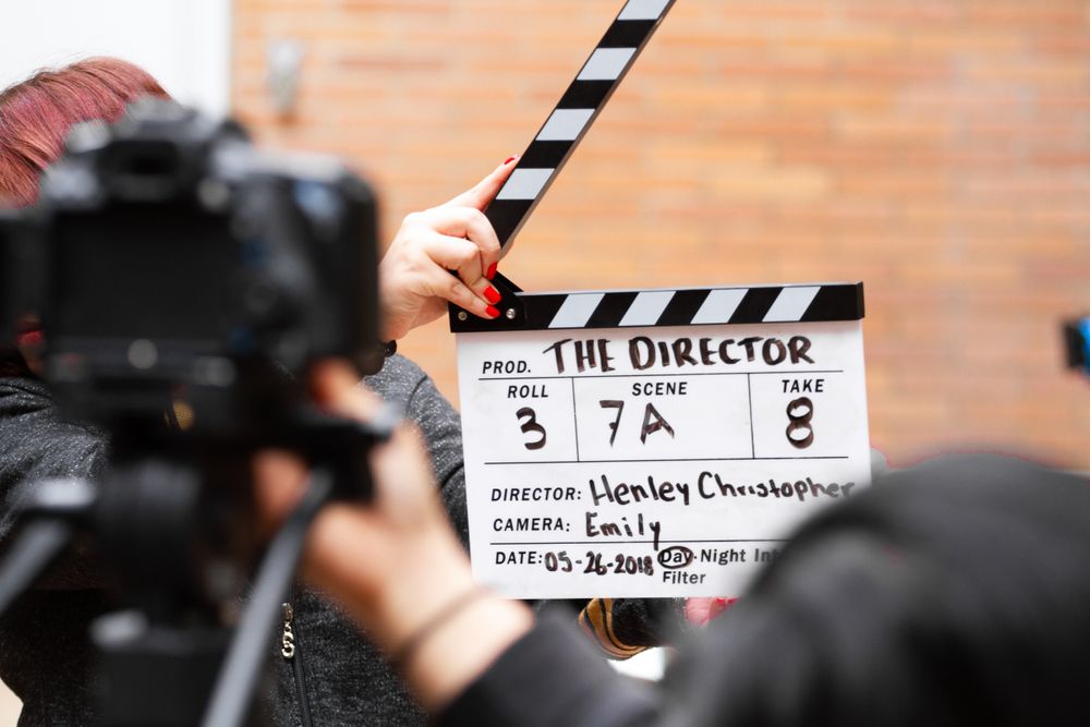 Cropped image of person holding clapperboard