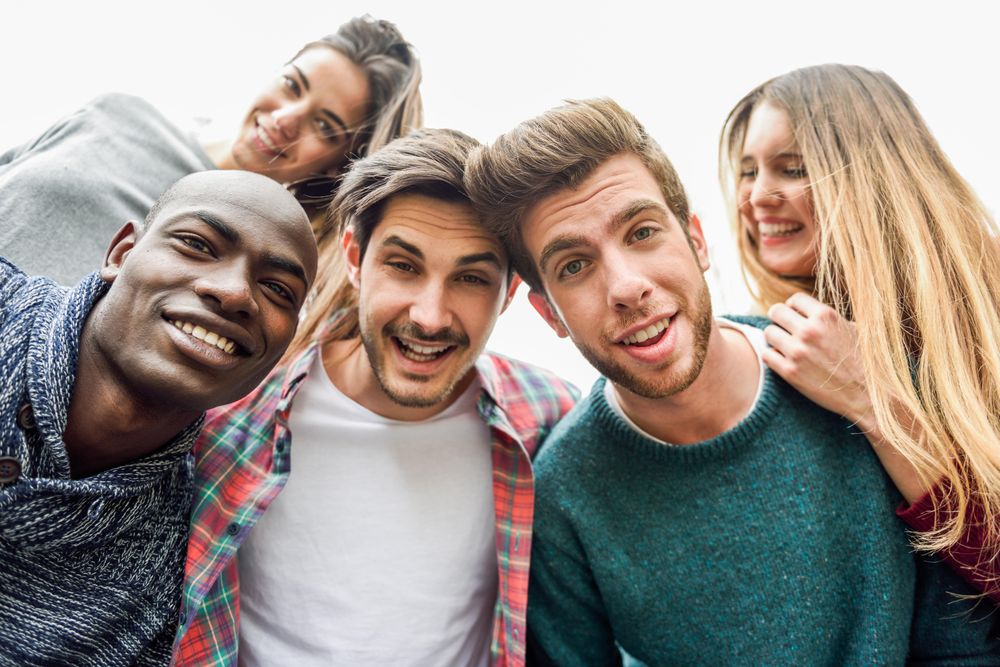 Group of adults looking down and smiling at camera