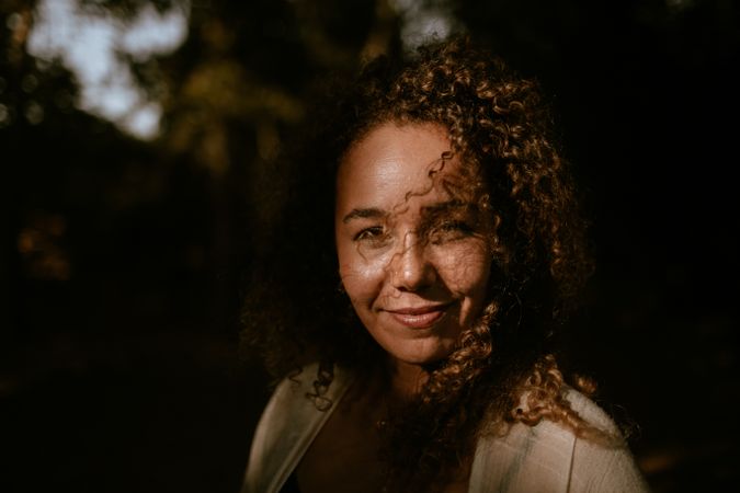 Smiling woman standing in forest