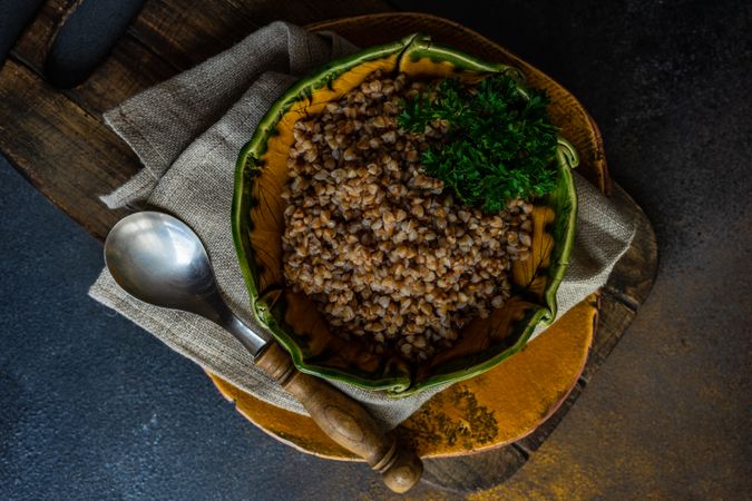 Bowl of buckwheat on wooden board