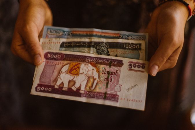 Person holding different money