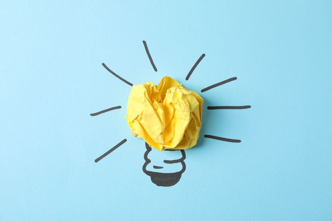 Drawn light bulb and paper ball on blue background. Good idea concept