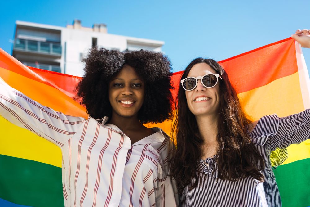 Female couple with LGBT flag
