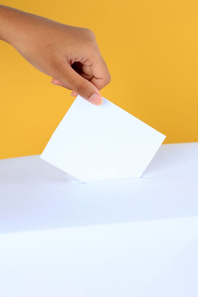 Female Hand Inserting Card Surat Suara to the Box Kotak.