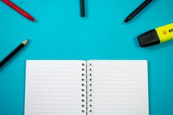 Open notebook with writing tools or school equipment