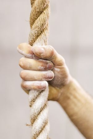 Man holding rope in gym
