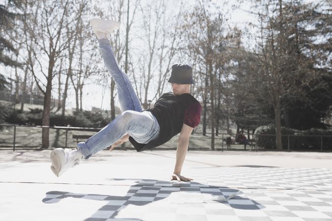 Man dancing break dance in park