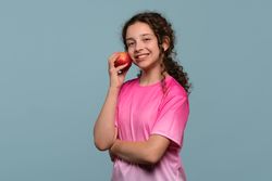 Girl smiling with a red apple