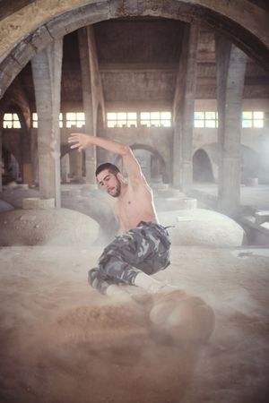 B boy performing dance in old cathedral
