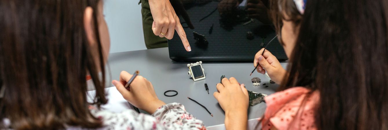 Teacher showing solar panel to her students in a robotics class
