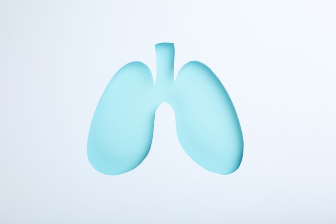 Blue lungs centered on light paper