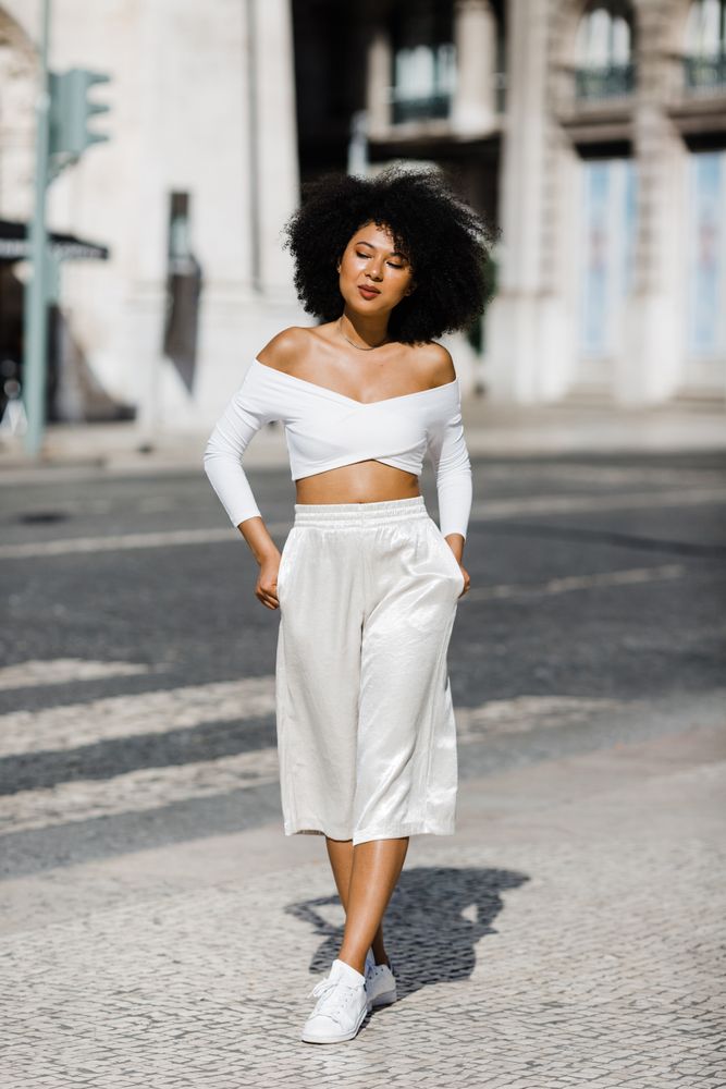 Young stylish female walking outdoors