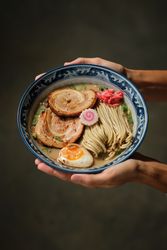 Anonymous woman with bowl of traditional ramen