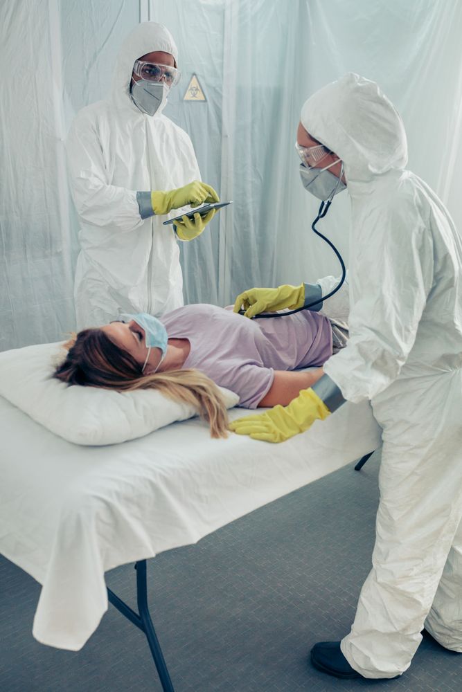 Doctors in a field hospital examining a patient