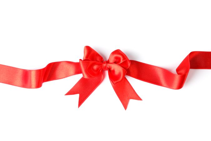 Red ribbon with bow isolated on plain background. Gift concept