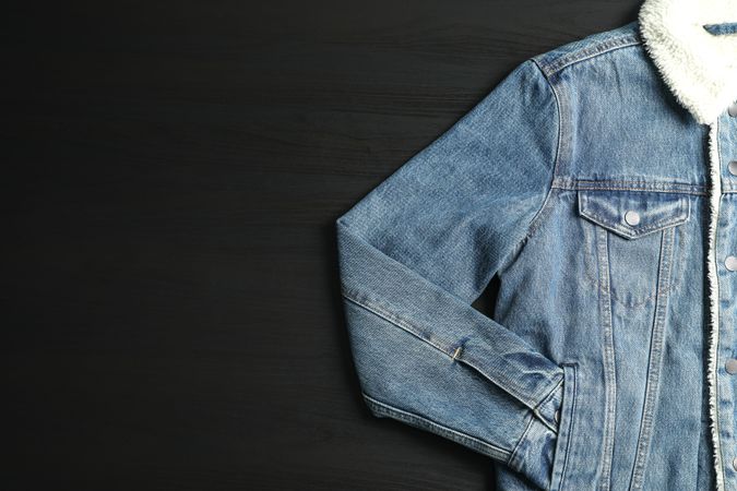 Denim jacket on background, space for text
