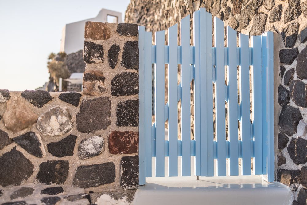 Wooden gate in rustic rock fence