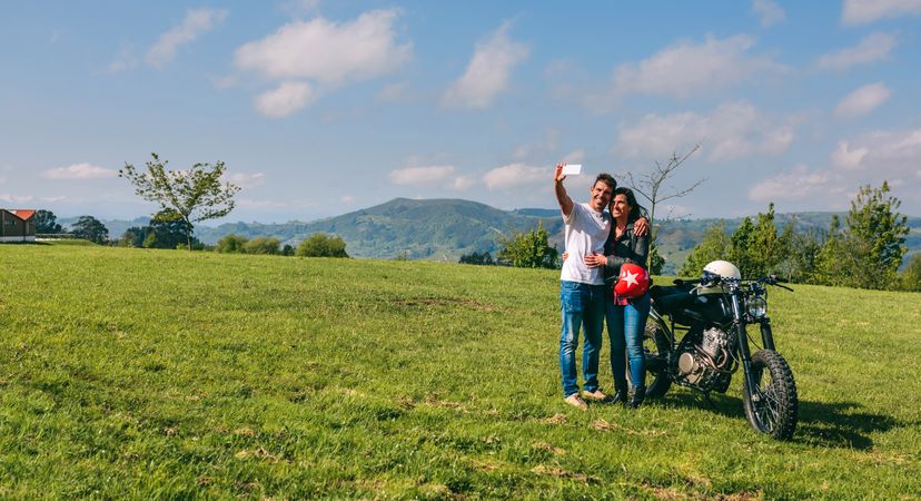 Couple taking a selfie with a motorcycle