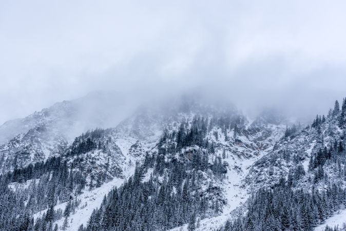 Snowy mountain peaks covered with fog in the Bavarian Alps, Germany