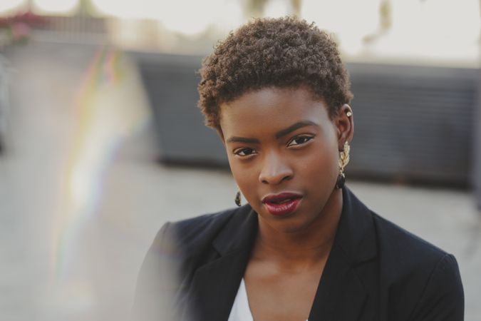 Charming confident Black elegant woman in costume on street