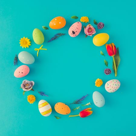 Easter eggs wreath on bright blue background