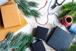 Christmas card concept with top view of gift boxes and tree branch