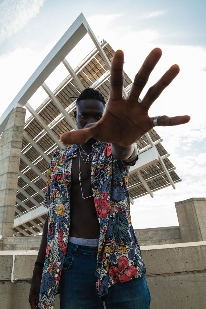 Stylish Black man with stop gesture