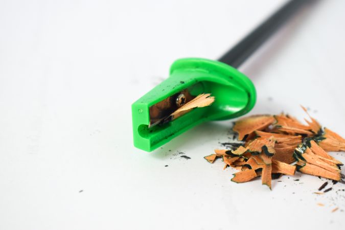Green pencil sharpener with shavings & space for text