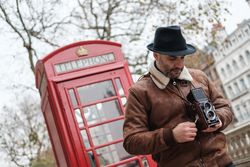 Male photographer near red telephone box