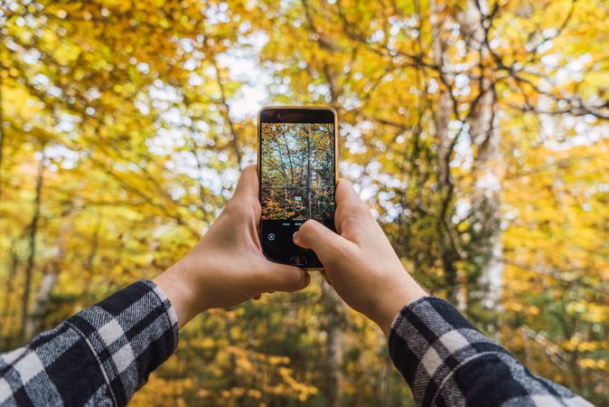 Casual tourist making photo on smartphone of nature