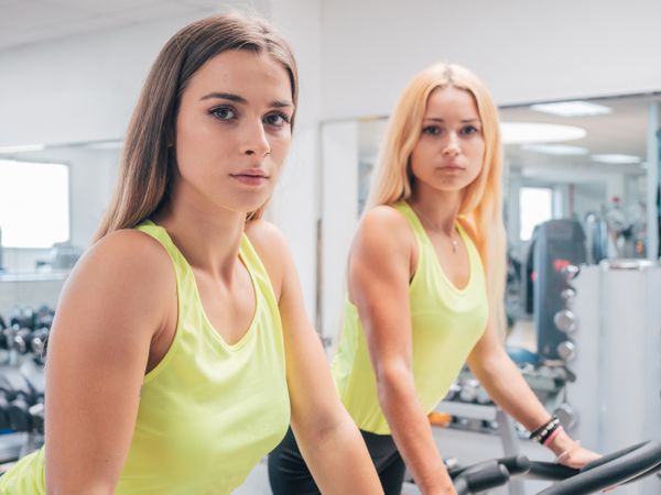 Young women exercising on machines together