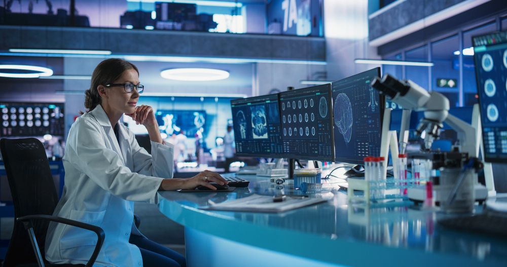 Medical Hospital Research Laboratory: Female Neurosurgeon Using Computer with Brain Scan MRI Images, Finding Best Treatment for Sick Patient.