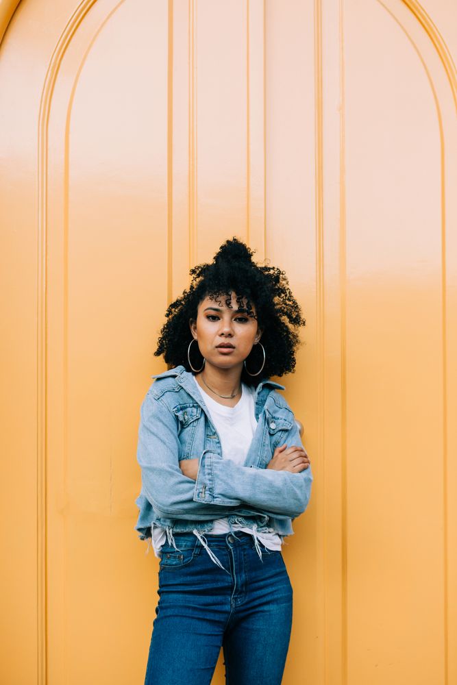 Stylish female by yellow door