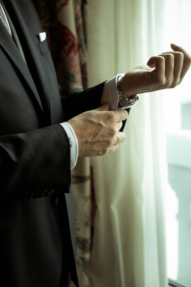 Man buttoning up shirt sleeve