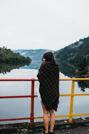Woman standing looking amazing lake near mountains