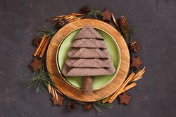 Holiday table setting with napkin in the shape of a tree, and wreath
