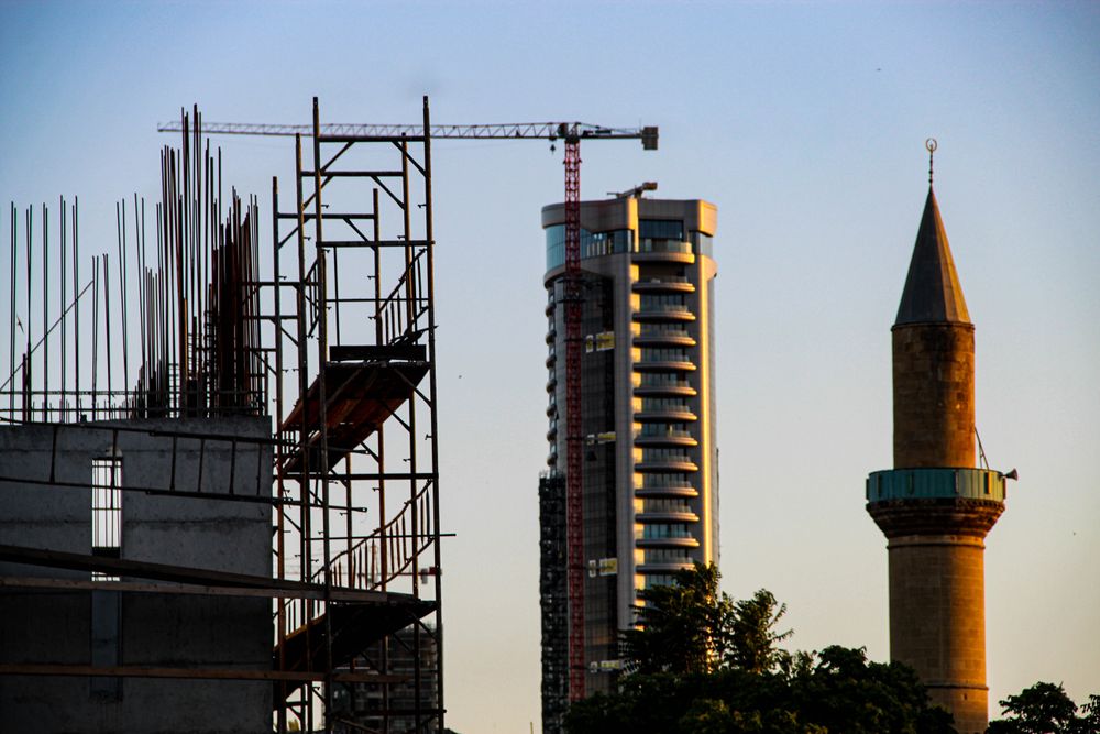 Scaffolding near a high rise building and minaret
