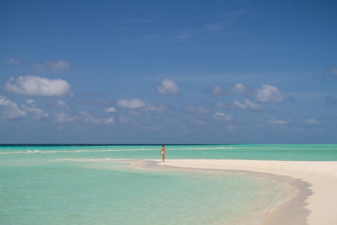 Unrecognizable female near turquoise sea