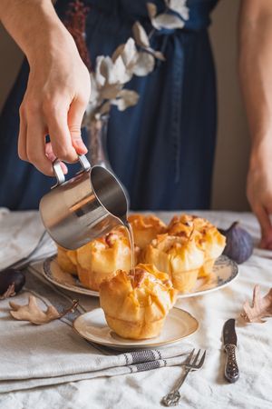 Baked galaktoboureko with person pouring syrup on top