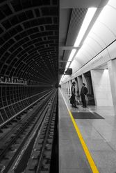 Two people waiting in subway