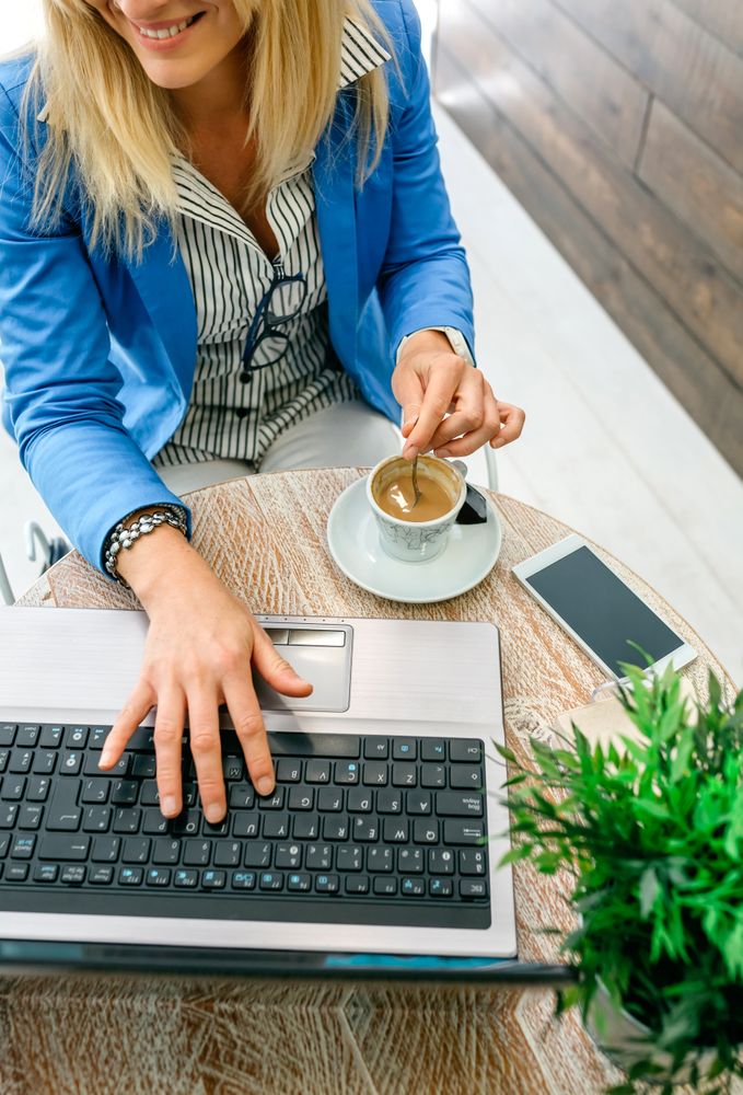 Businesswoman working during coffee break