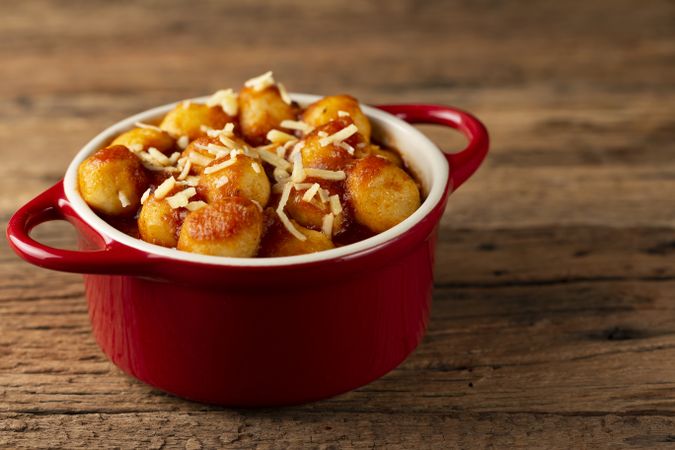 Gnocchi with tomato sauce and grated Parmesan cheese.